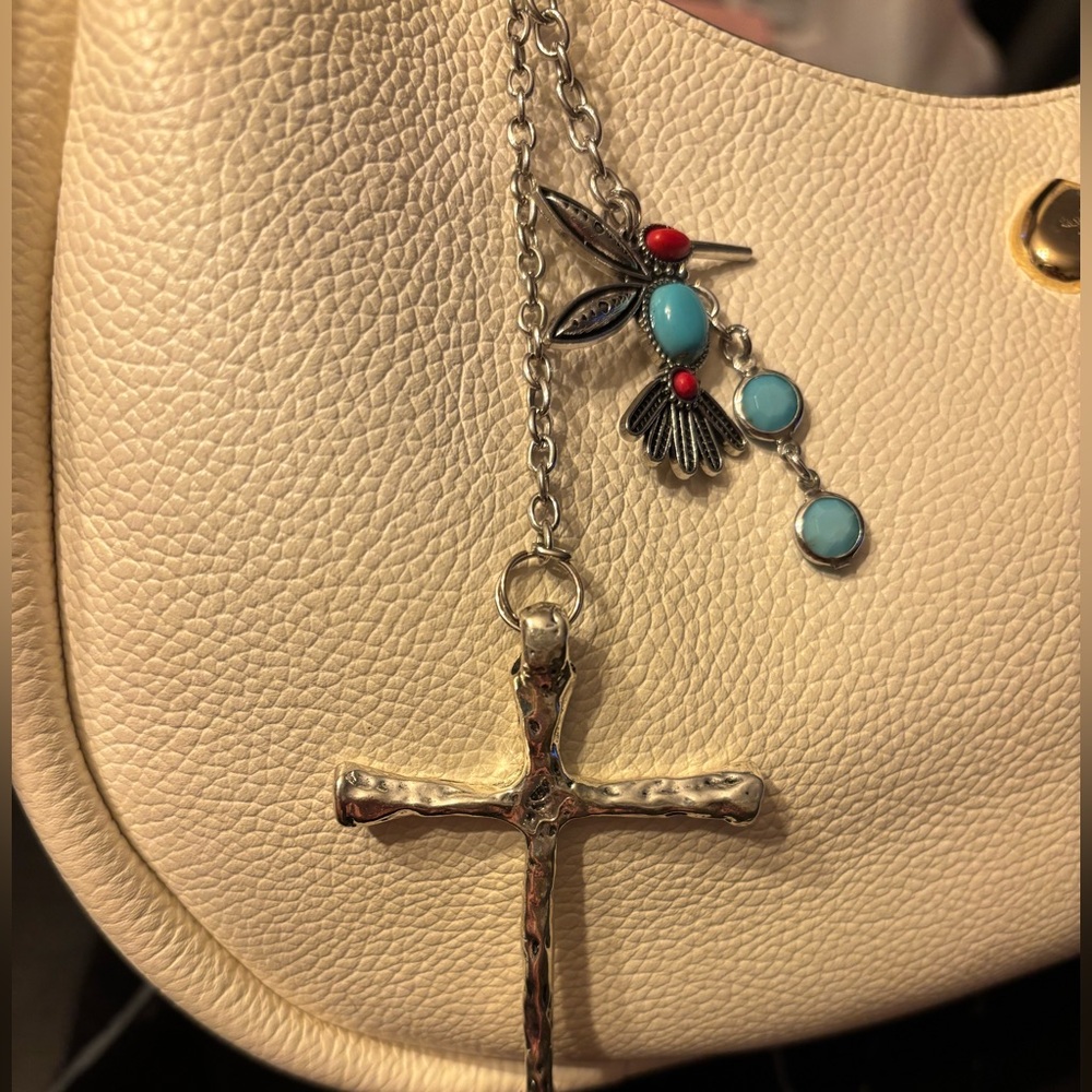 Silver Cross with turquoise hummingbird bag charm.